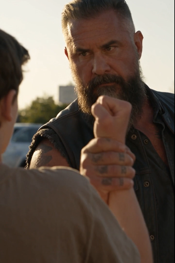 He Grabbed The Teenager’s Ankle Mid-Kick—And For A Split Second, Everyone Thought The Biker Was About To Start A War In The Parking Lot.